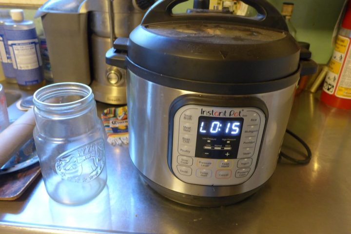 An Instant Pot electric pressure cooker on a stainless steel kitchen counter