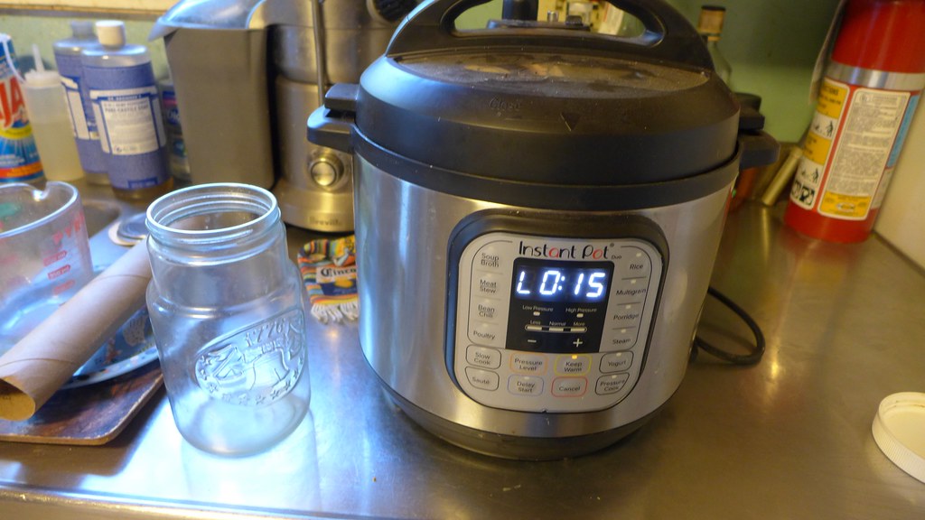 An Instant Pot electric pressure cooker on a stainless steel kitchen counter