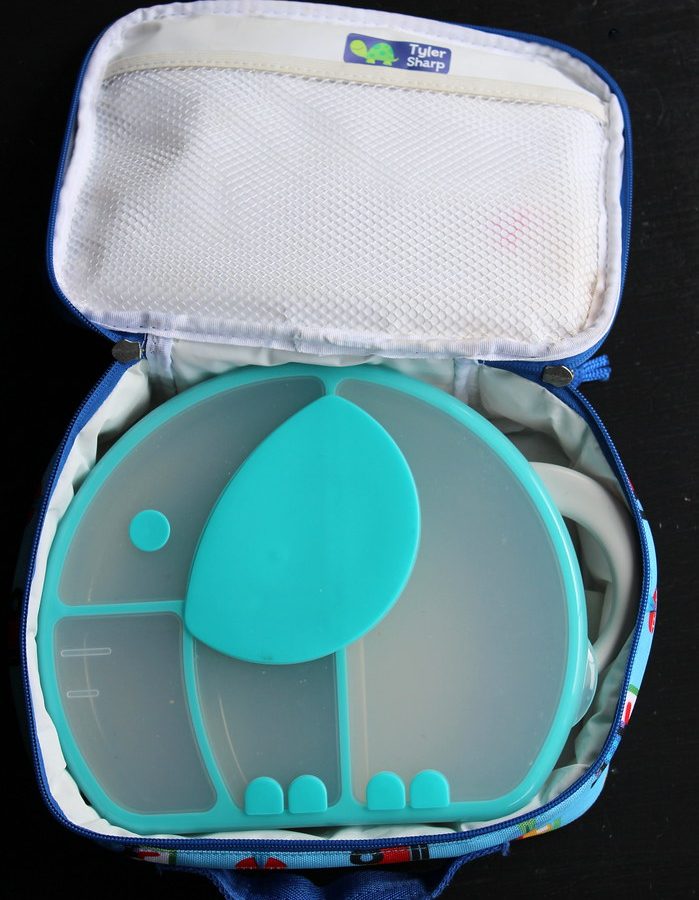 A children's divided snack box inside an open insulated lunch bag